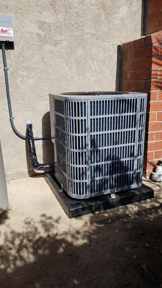 New outdoor condenser installed beside a house