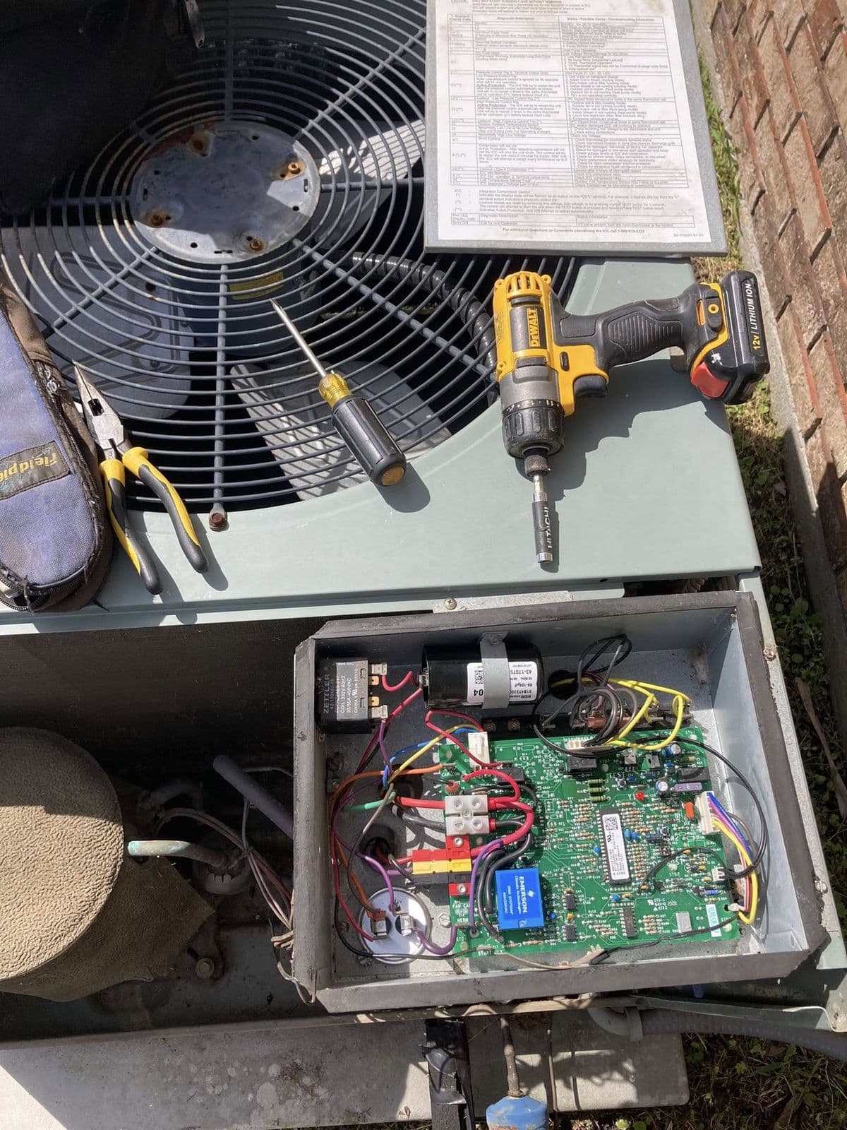 Control board and capacitor inside an outdoor unit with the panel removed