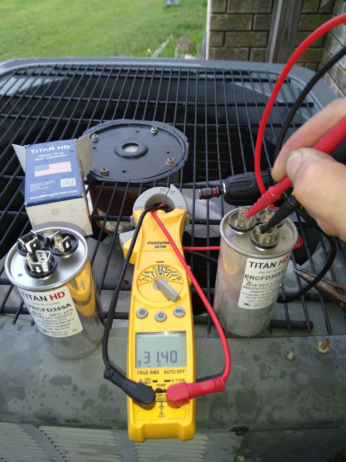 Technician testing a run capacitor with a multimeter