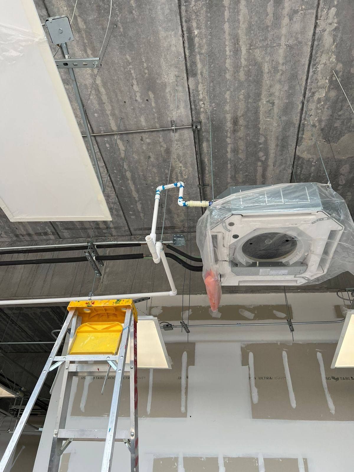 Ceiling cassette ductless unit being installed