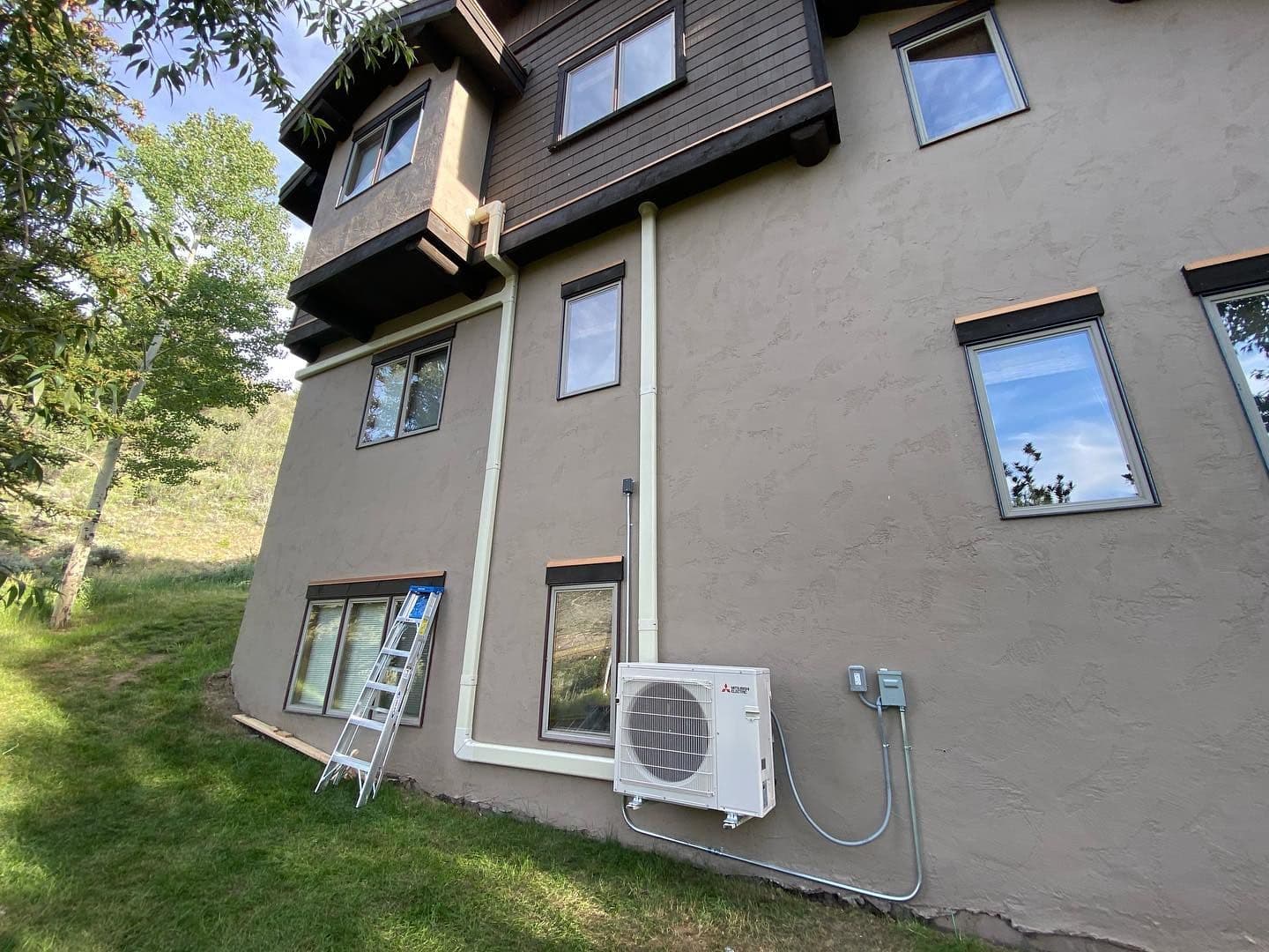 Mini split outdoor unit on a two story house