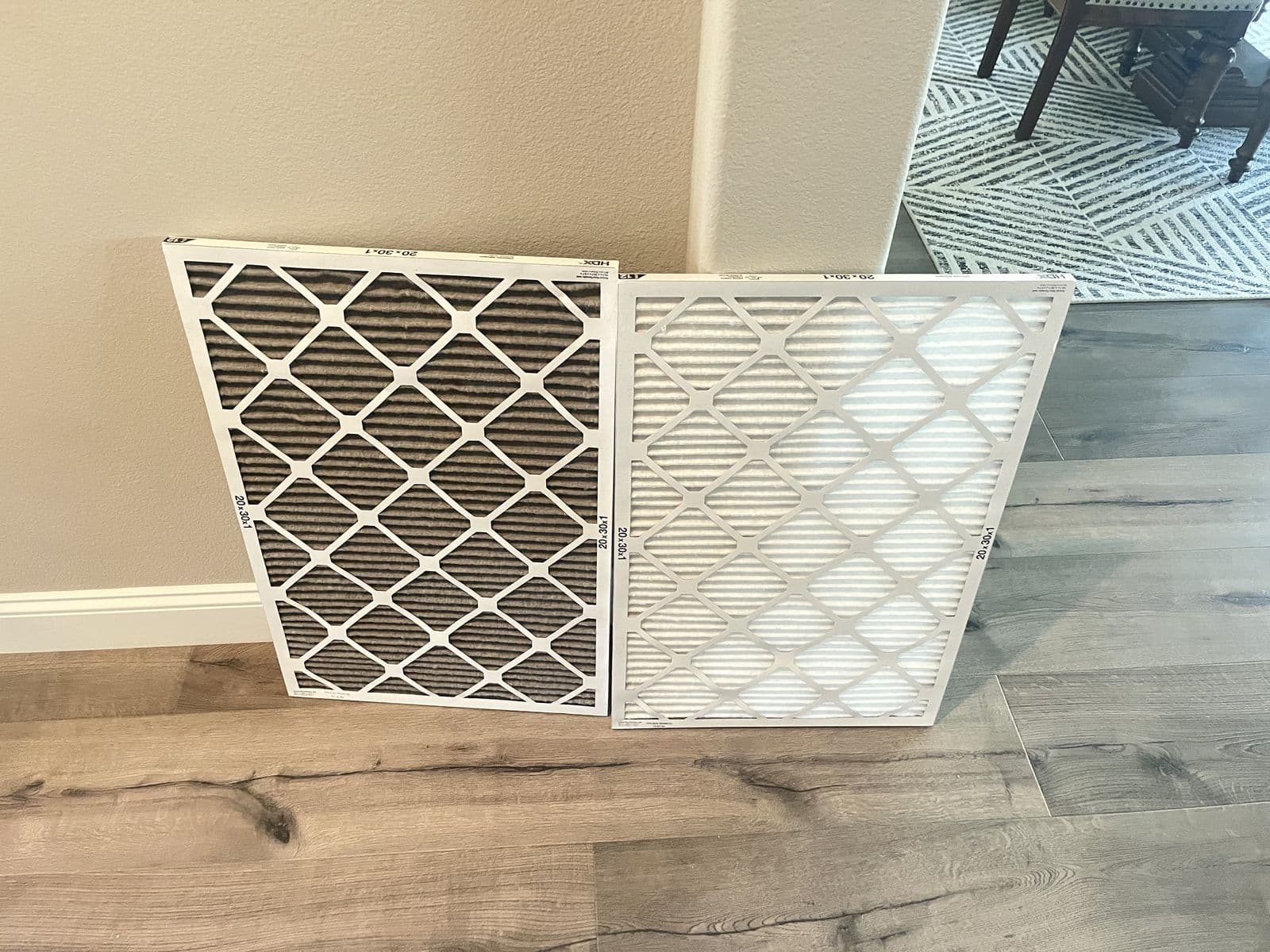 Dirty and clean pleated filters leaning against a wall