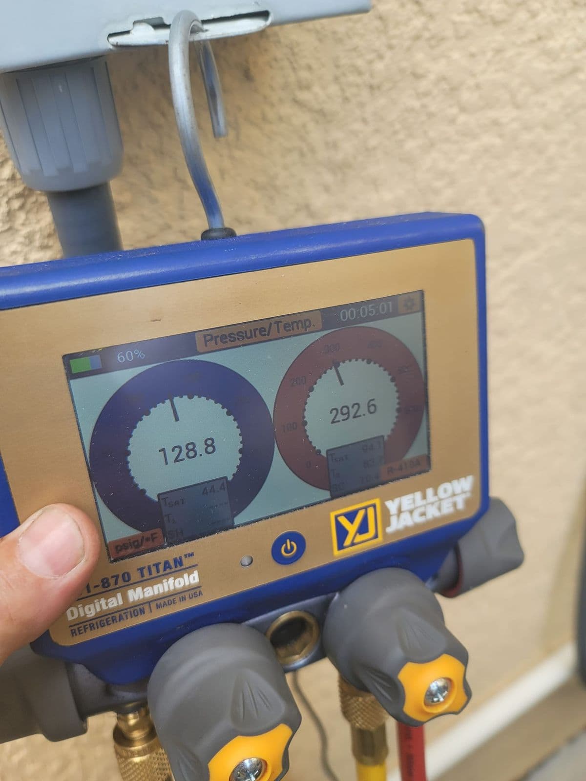 Digital manifold gauges used to read refrigerant pressures during a service call