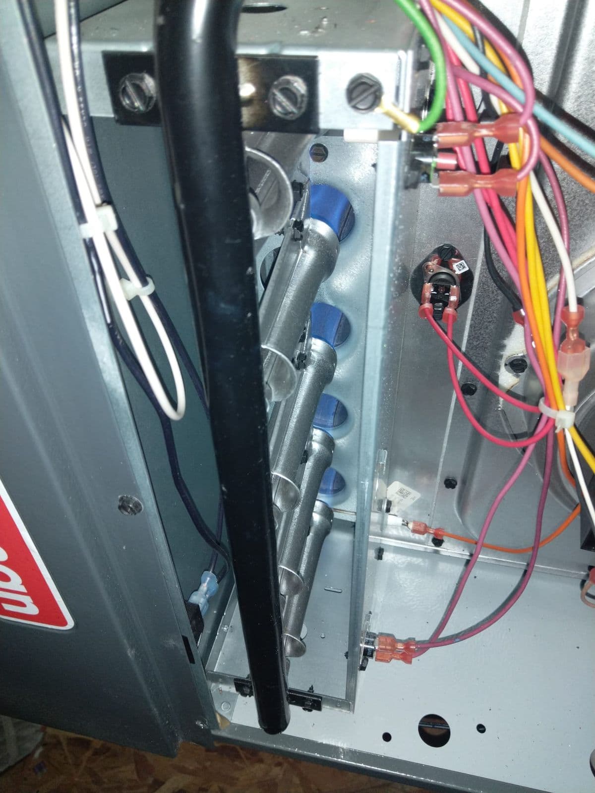 Outdoor unit control panel open for inspection of the wiring and contactor
