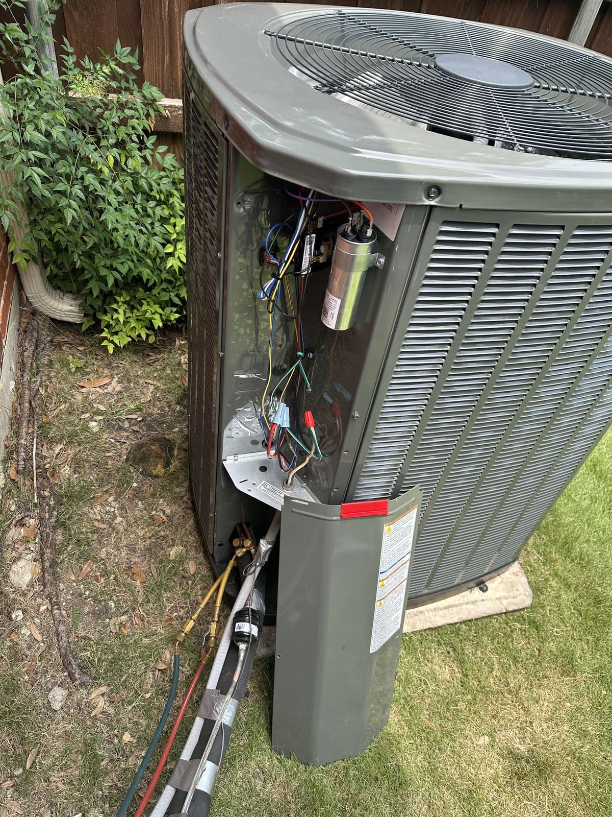 Outdoor unit with the cabinet open showing the coil and electrical panel