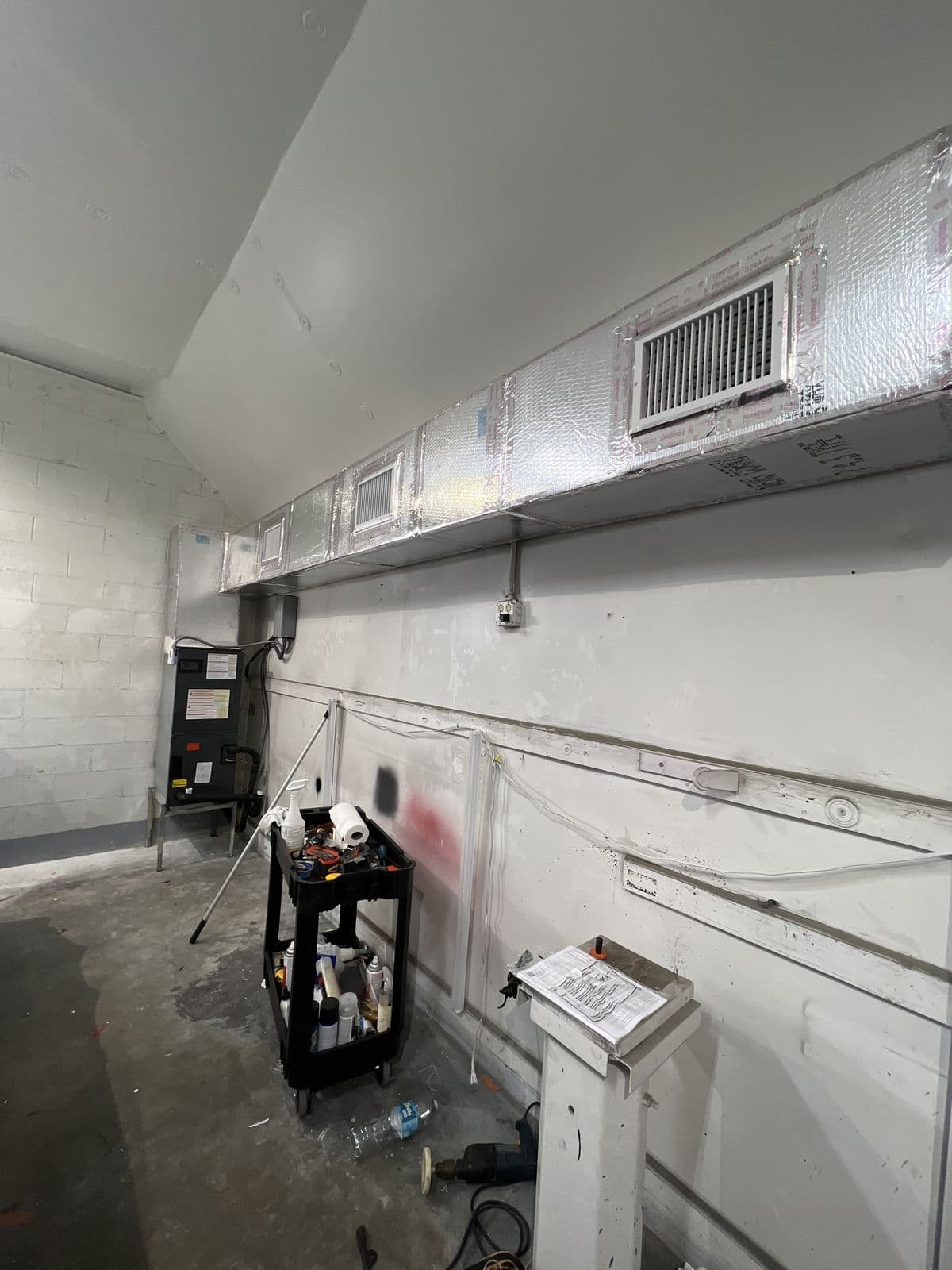 Metal ductwork running along the ceiling of a commercial room