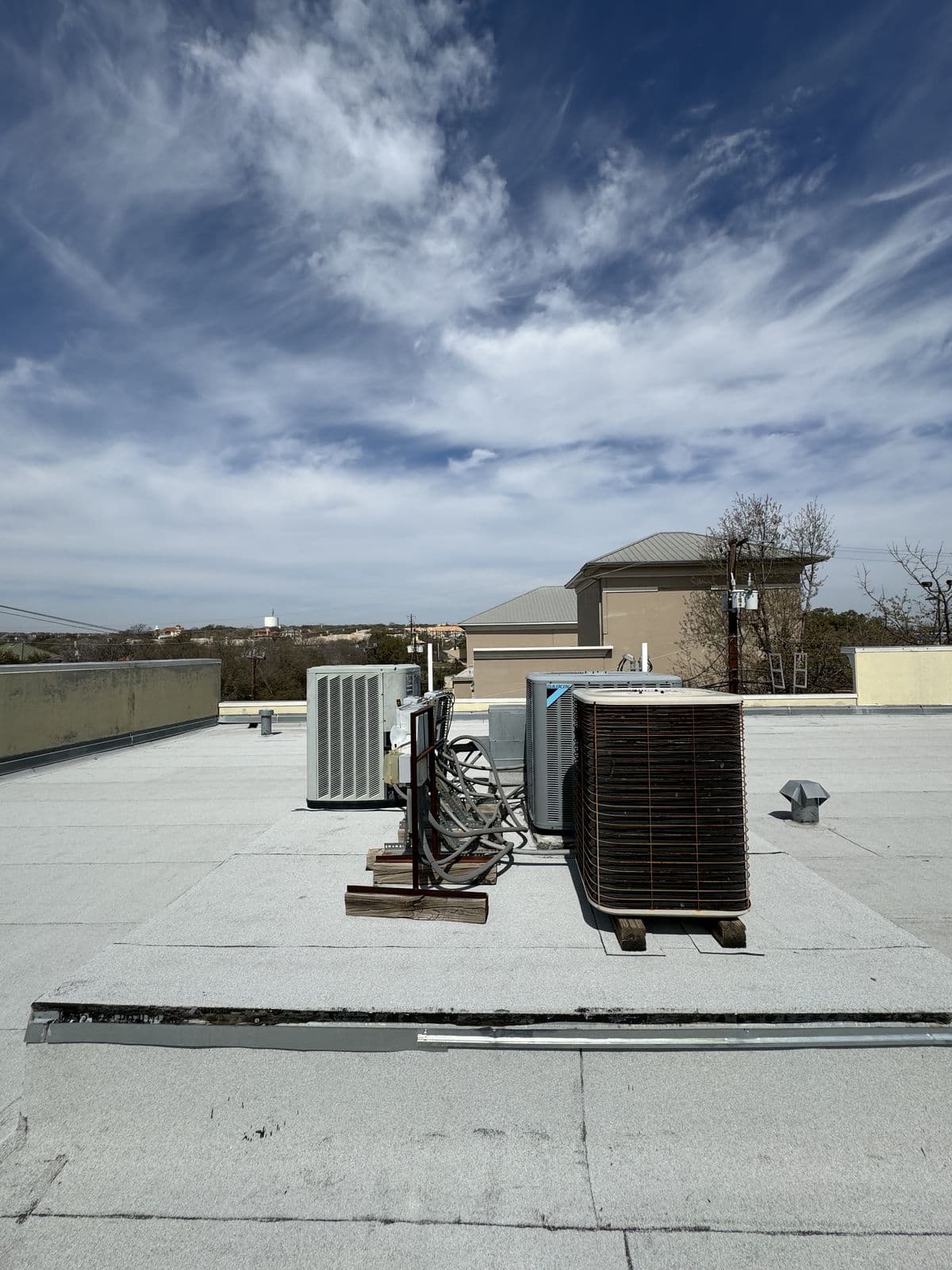 Rooftop condensing units on a flat commercial roof