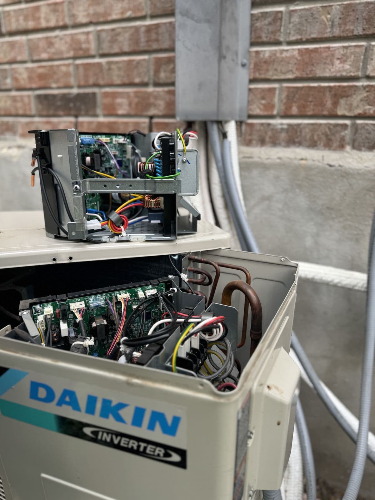 Daikin outdoor unit open for service showing the control boards