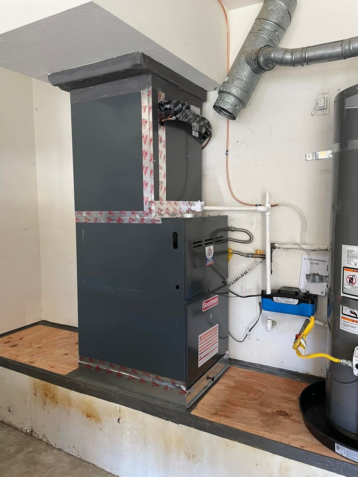 Furnace next to a water heater in a utility room