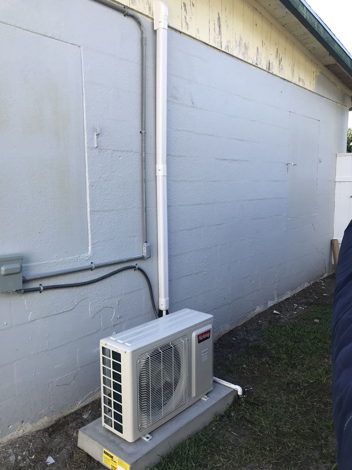 Ductless heat pump outdoor unit on a pad