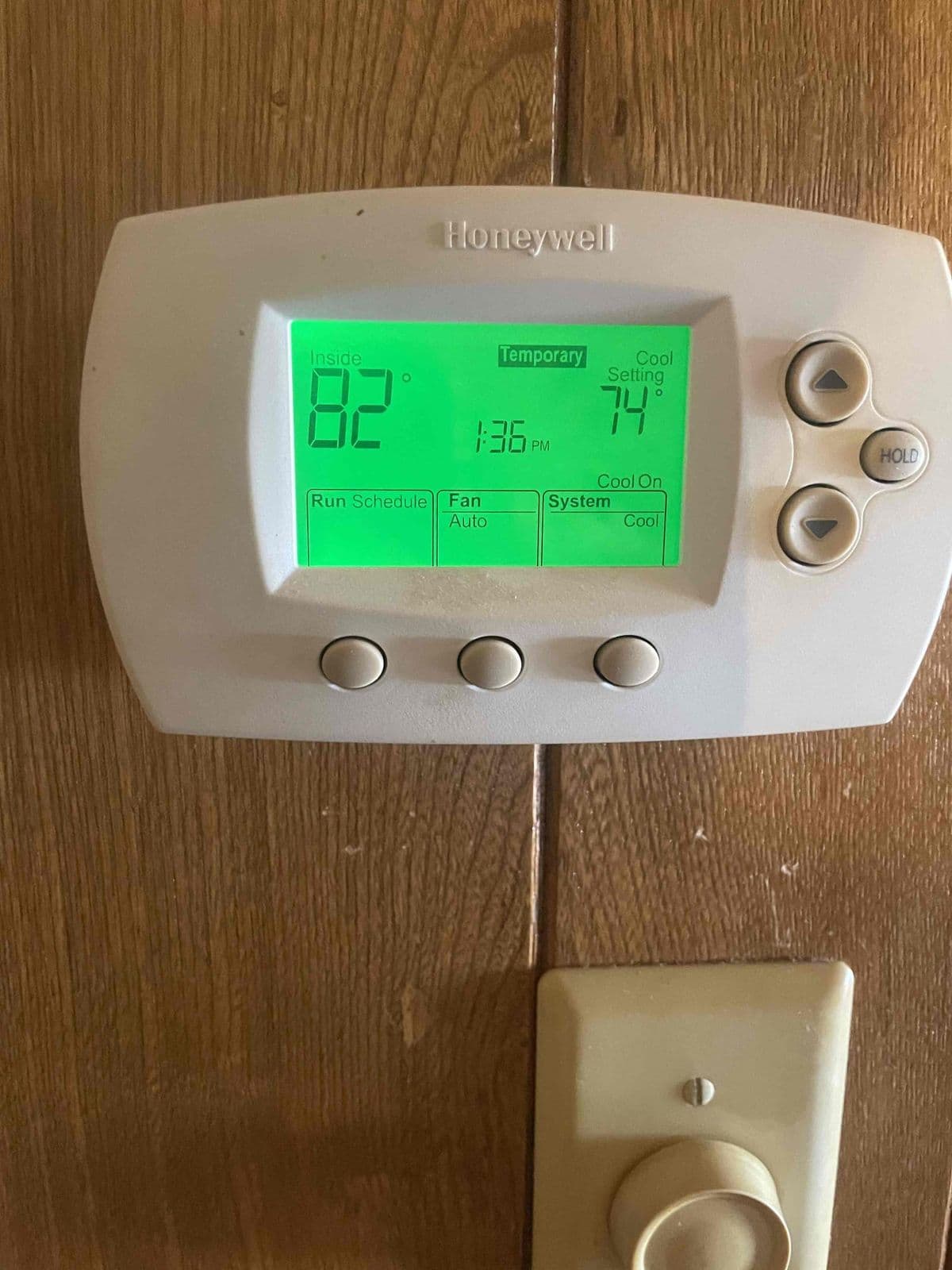Digital thermostat on a wood wall