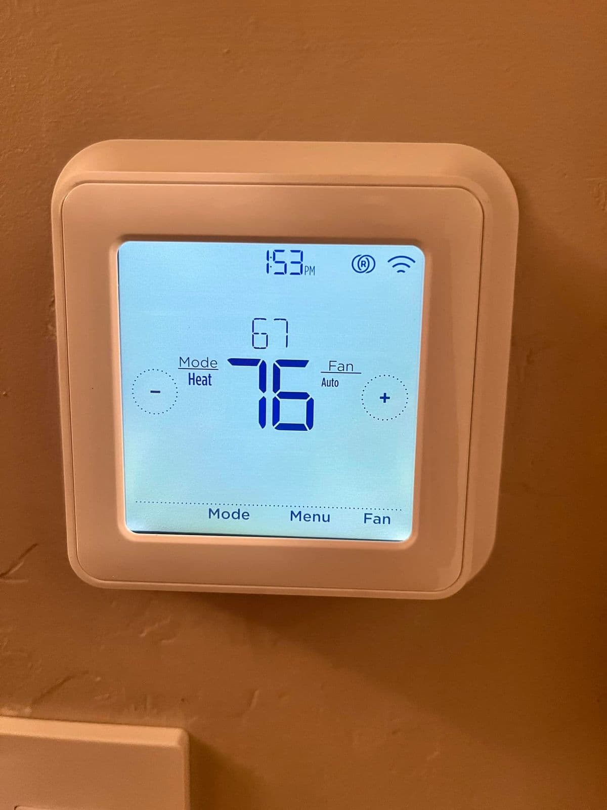 Digital thermostat showing 76