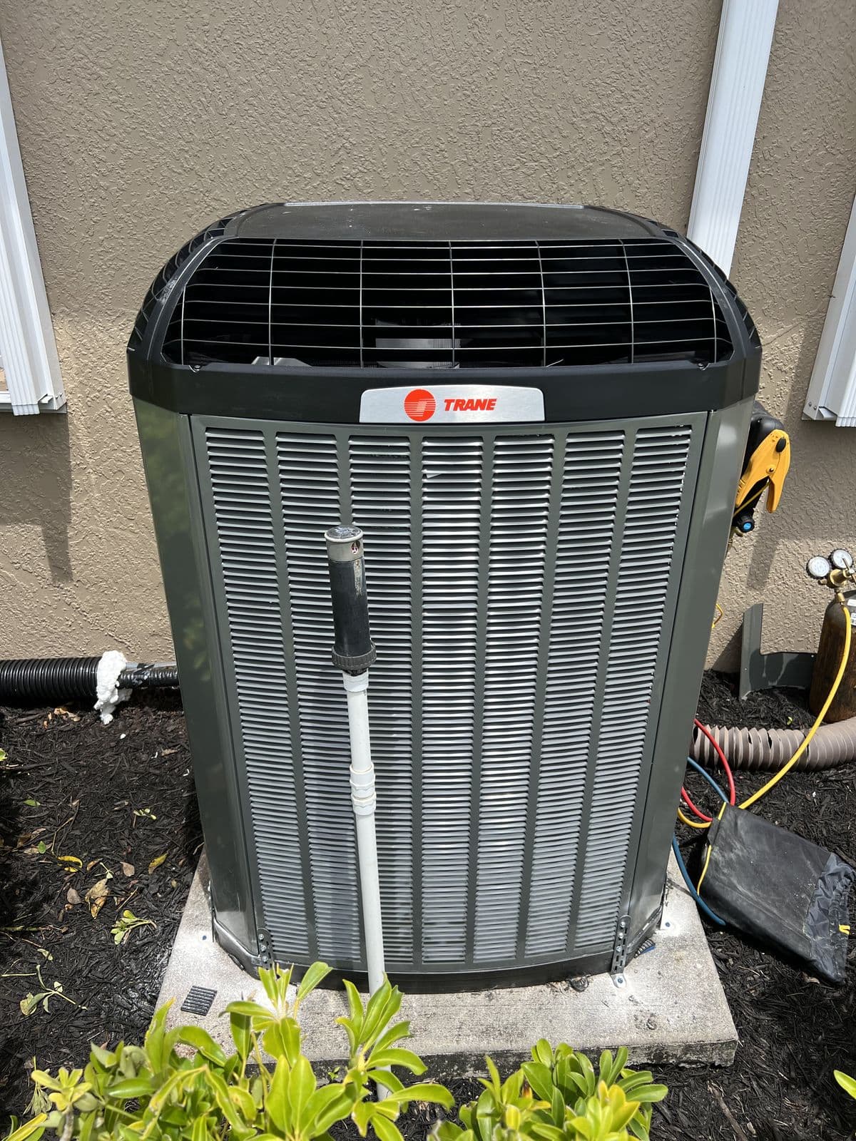 Trane condenser beside a house